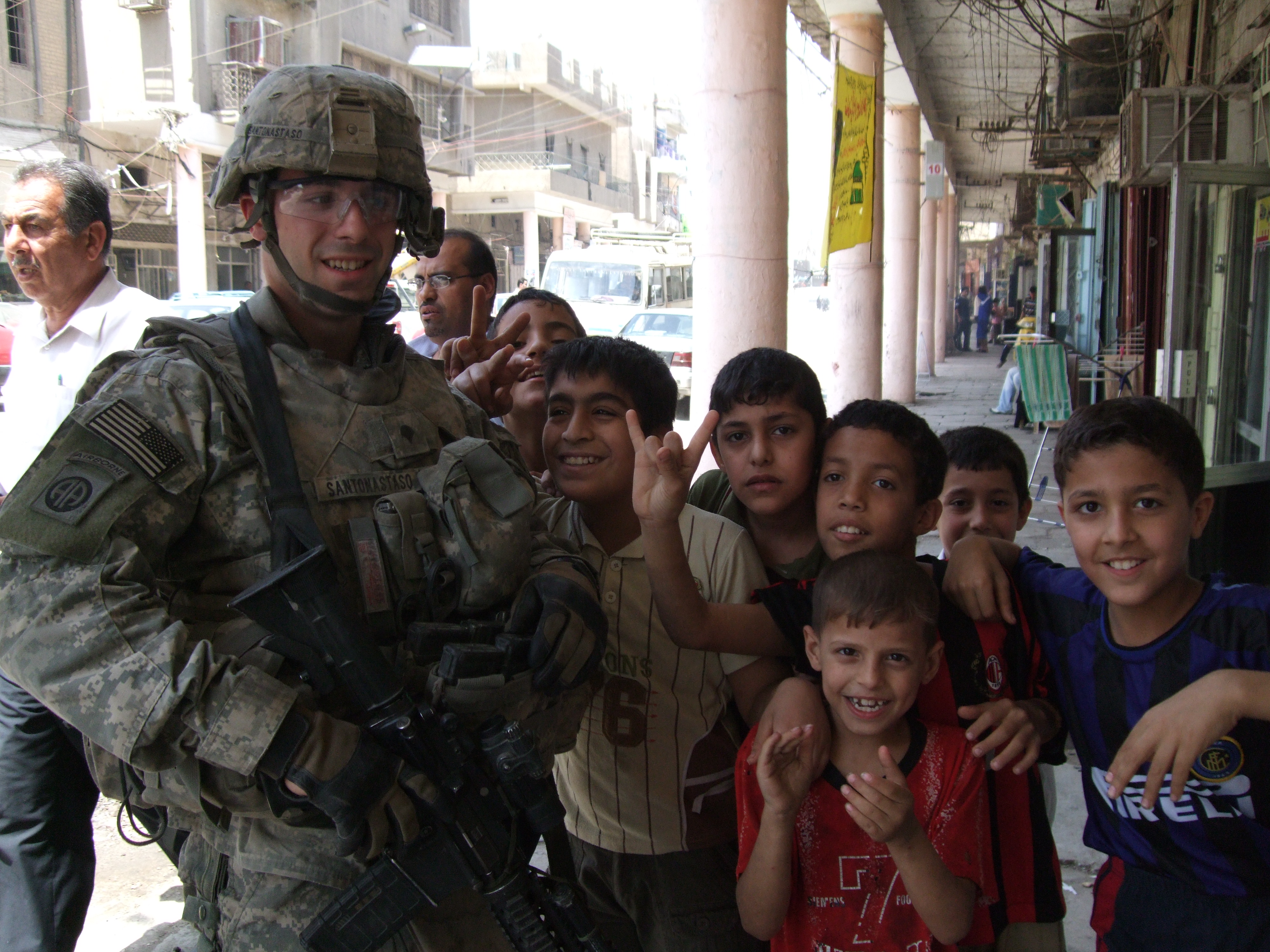 Matthew Santonastaso with local children during his military service